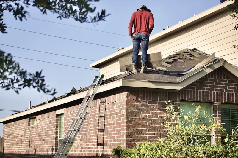 Professional roofer working on a residential roof in Old Lyme Shores